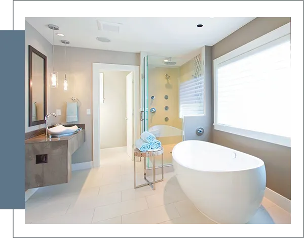 A bathroom with a large tub and a sink.