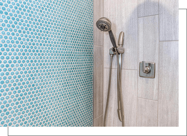 A shower with a blue and white polka dot wall.